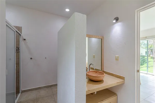 a bedroom with a bed and a potted plant