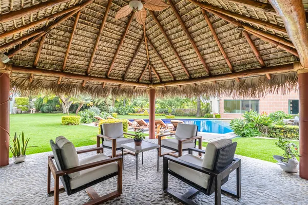 a backyard of a house with outdoor seating