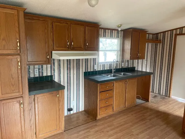 a kitchen with granite countertop cabinets and window