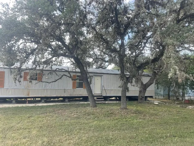 a view of a backyard with large trees