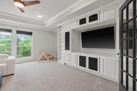 a living room with furniture windows and flat screen tv
