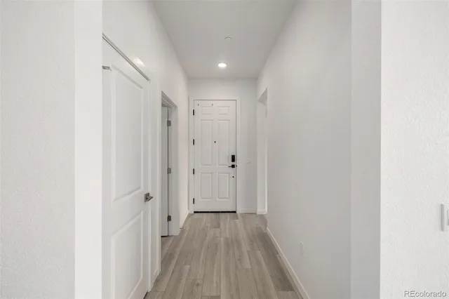 a view of a hallway with wooden floor