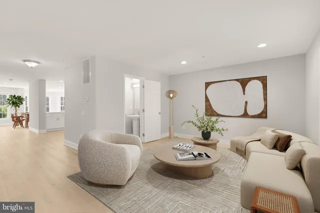 a living room with furniture and a mirror