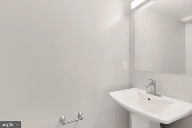a bathroom with a sink and mirror