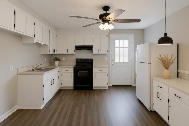 a kitchen with stainless steel appliances granite countertop a refrigerator a sink dishwasher a stove and white countertops with wooden floor