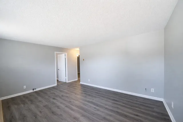a view of an empty room and wooden floor