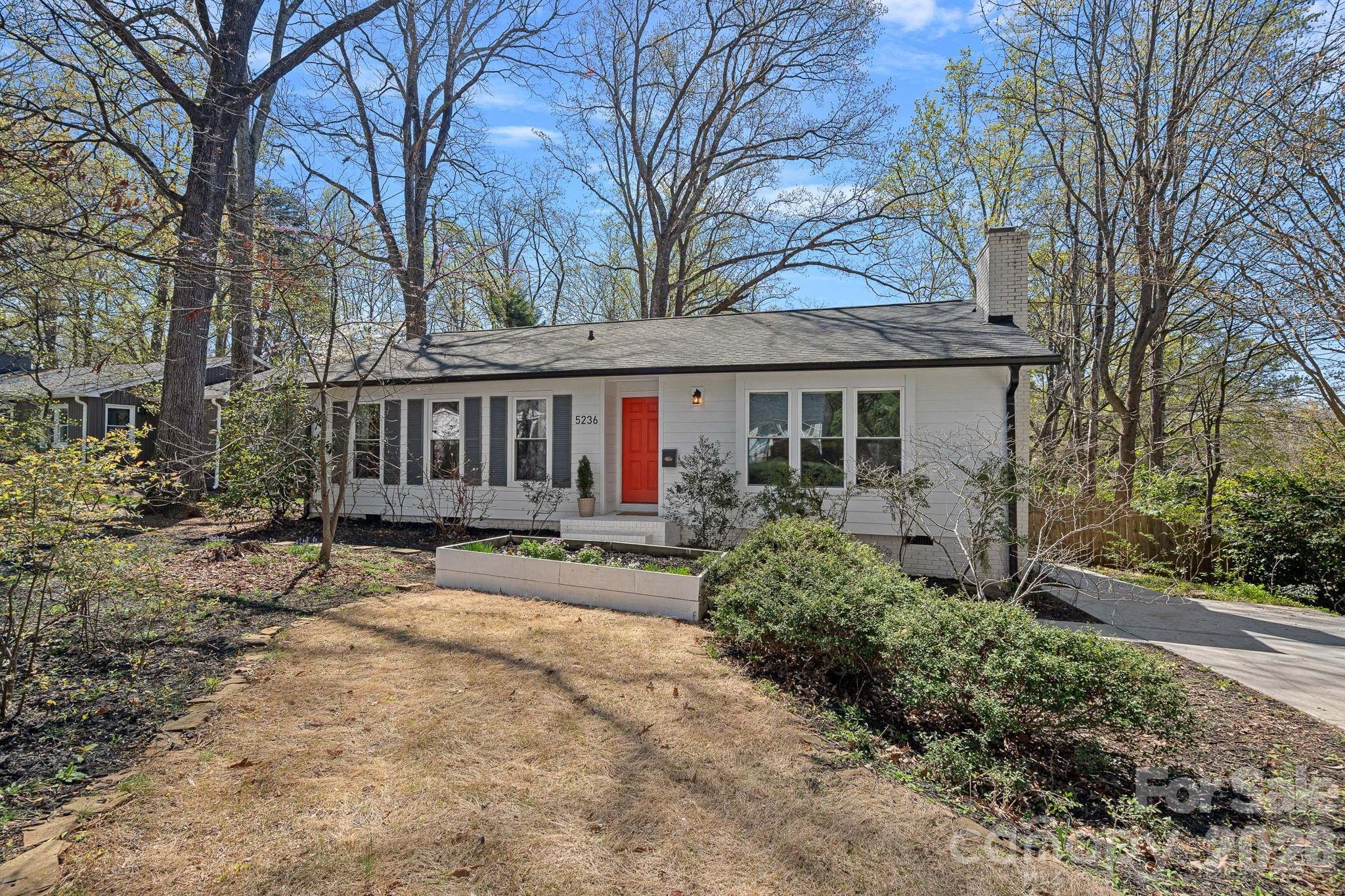 5236 Auburndale Road Charlotte, NC 28205 - Photo 1 of 26 a view of a house with a yard and potted plants