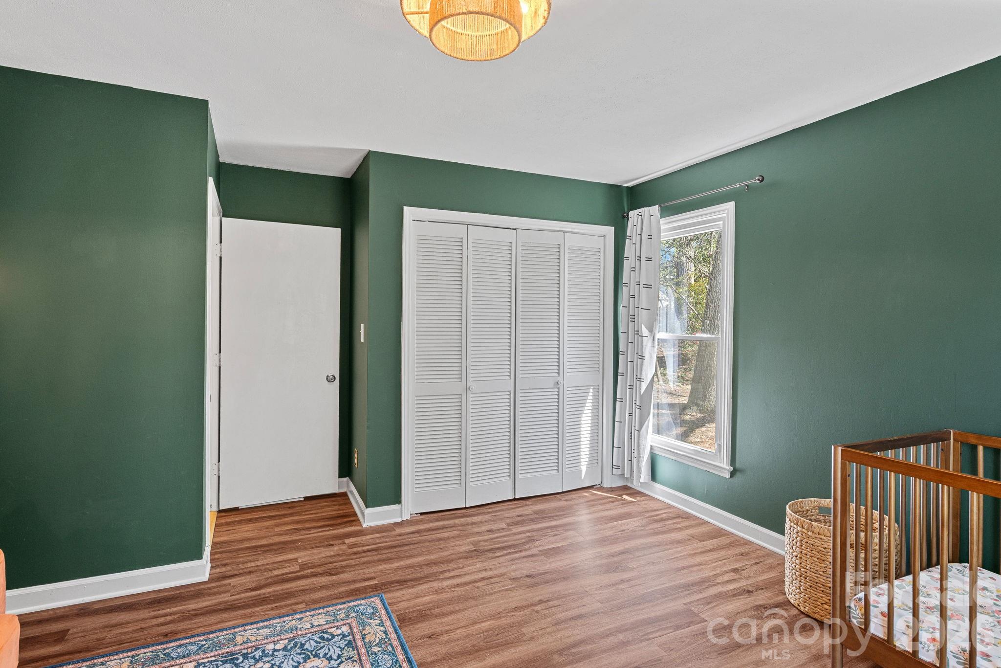 5236 Auburndale Road Charlotte, NC 28205 - Photo 18 of 26 a view of an empty room with wooden floor and a window