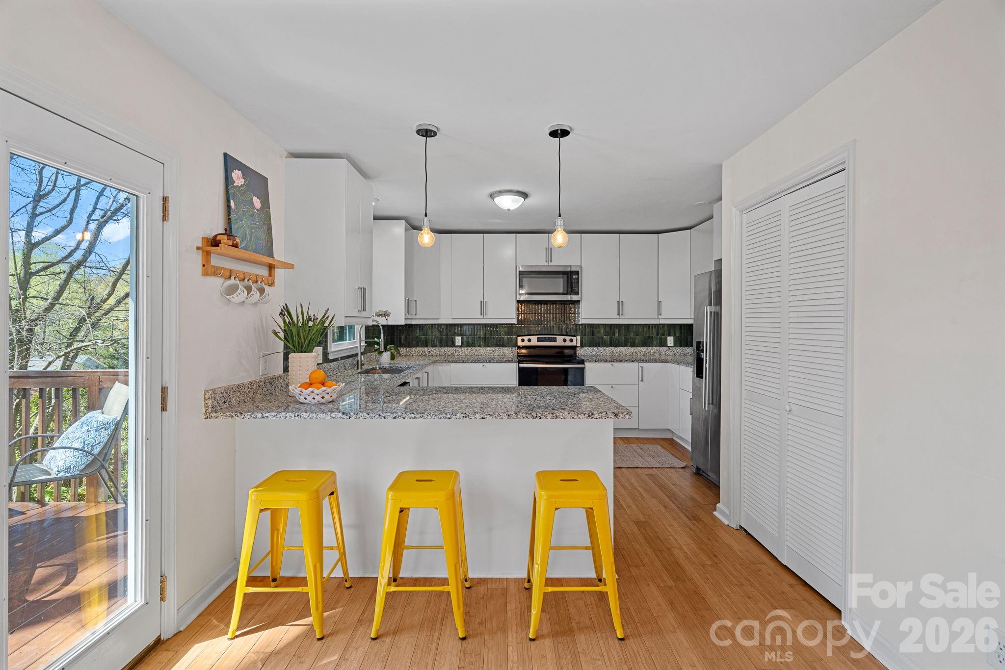 5236 Auburndale Road Charlotte, NC 28205 - Photo 8 of 26 a kitchen with stainless steel appliances a sink a stove a refrigerator cabinets and a window