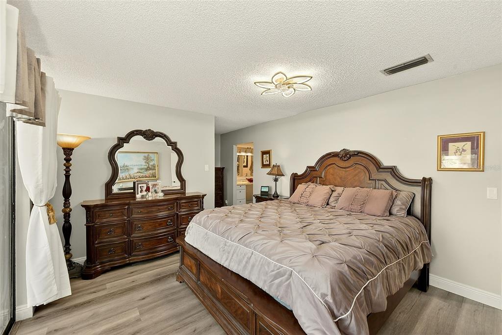 700 Starkey Road, Unit 1216 Largo, FL 33771 - Photo 14 of 32 a bedroom with a bed and a dresser