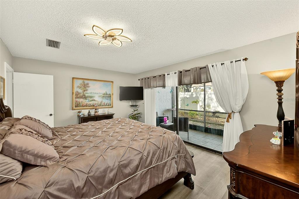 700 Starkey Road, Unit 1216 Largo, FL 33771 - Photo 15 of 32 a bedroom with a bed a window and dresser