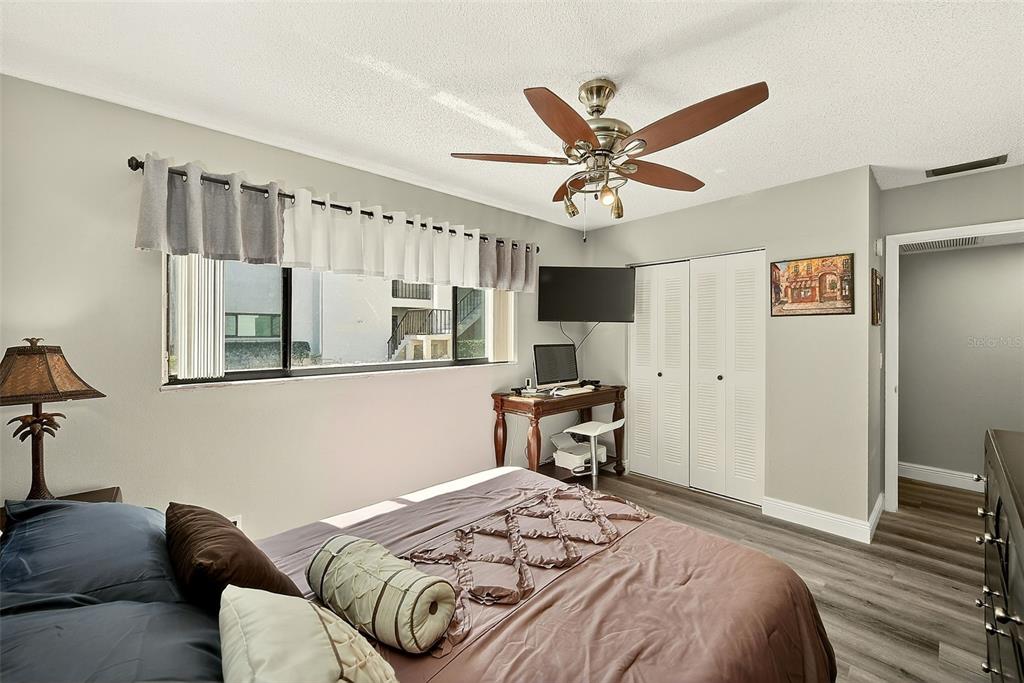 700 Starkey Road, Unit 1216 Largo, FL 33771 - Photo 23 of 32 a bedroom with a bed and a chandelier