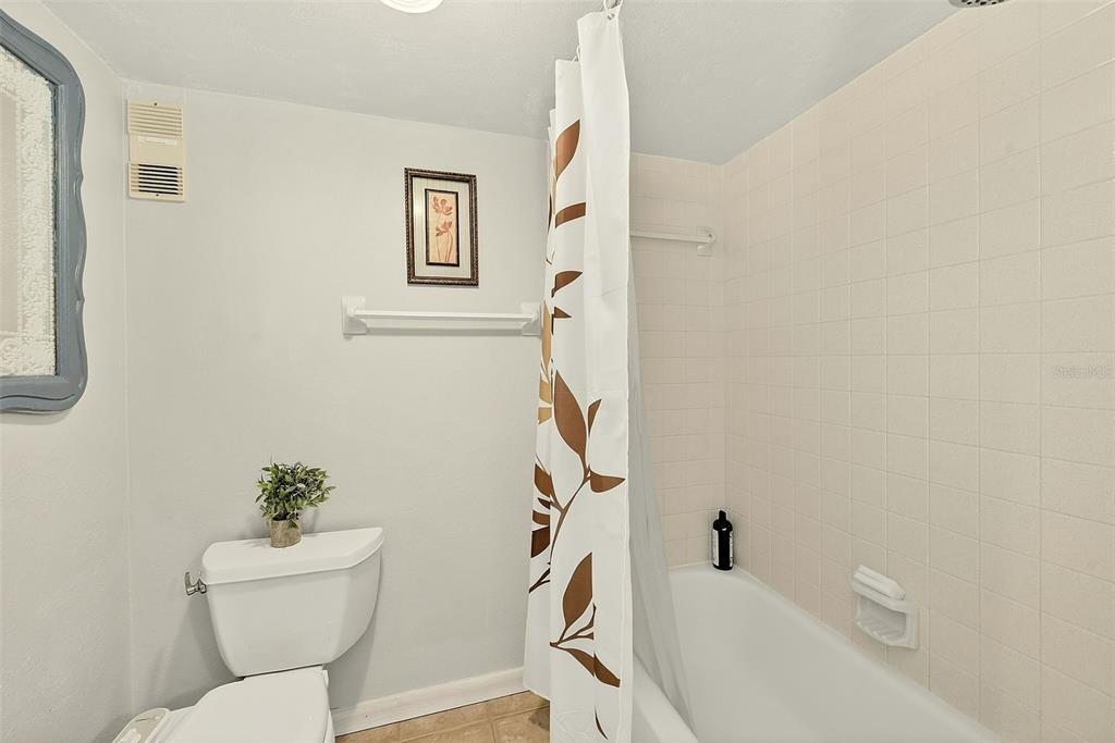 700 Starkey Road, Unit 1216 Largo, FL 33771 - Photo 25 of 32 a bathroom with a sink a toilet and a mirror