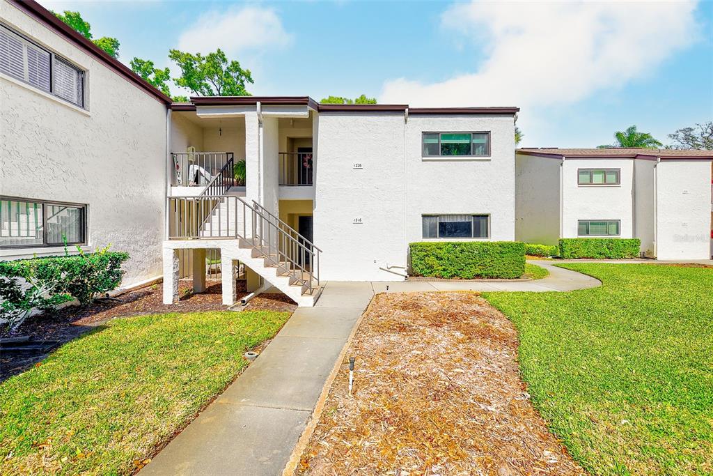 700 Starkey Road, Unit 1216 Largo, FL 33771 - Photo 28 of 32 a front view of a house with a yard