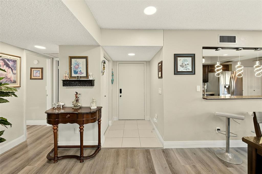 700 Starkey Road, Unit 1216 Largo, FL 33771 - Photo 3 of 32 a view of a workspace with furniture and wooden floor