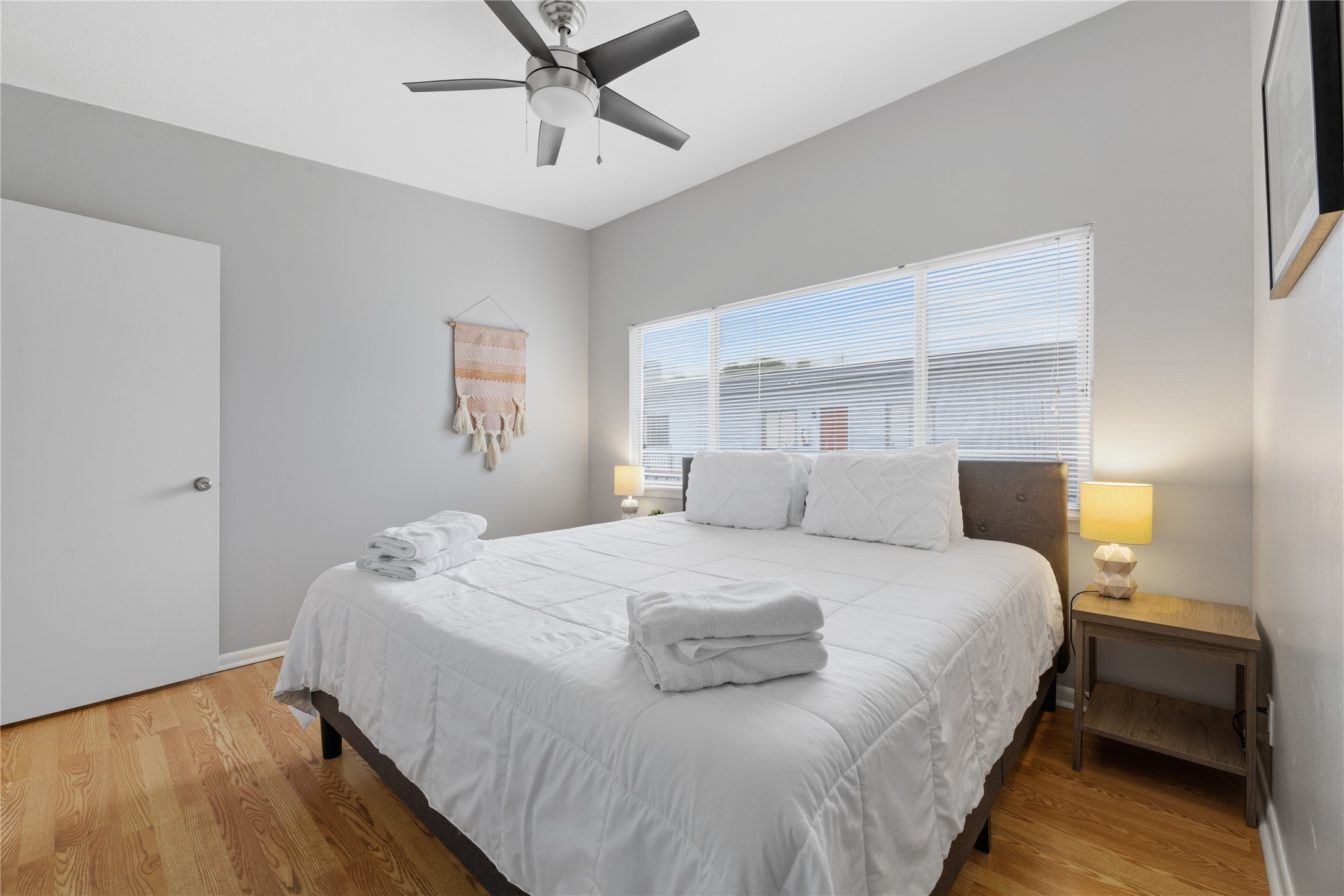 2408 Longview Street, Unit 204 Austin, TX 78705 - Photo 12 of 17 a bedroom with a bed and wooden floor