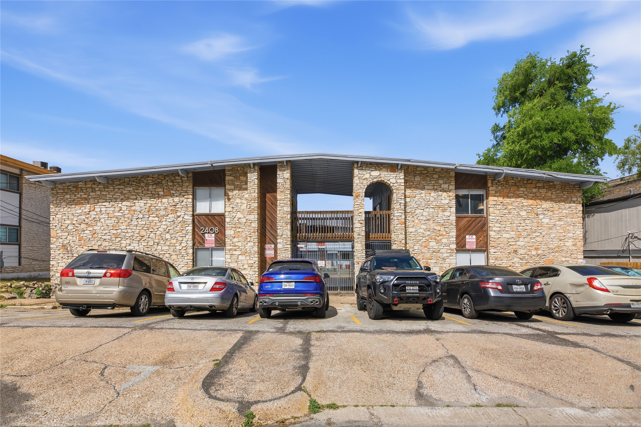2408 Longview Street, Unit 204 Austin, TX 78705 - Photo 13 of 17 a view of cars parked in front of a house