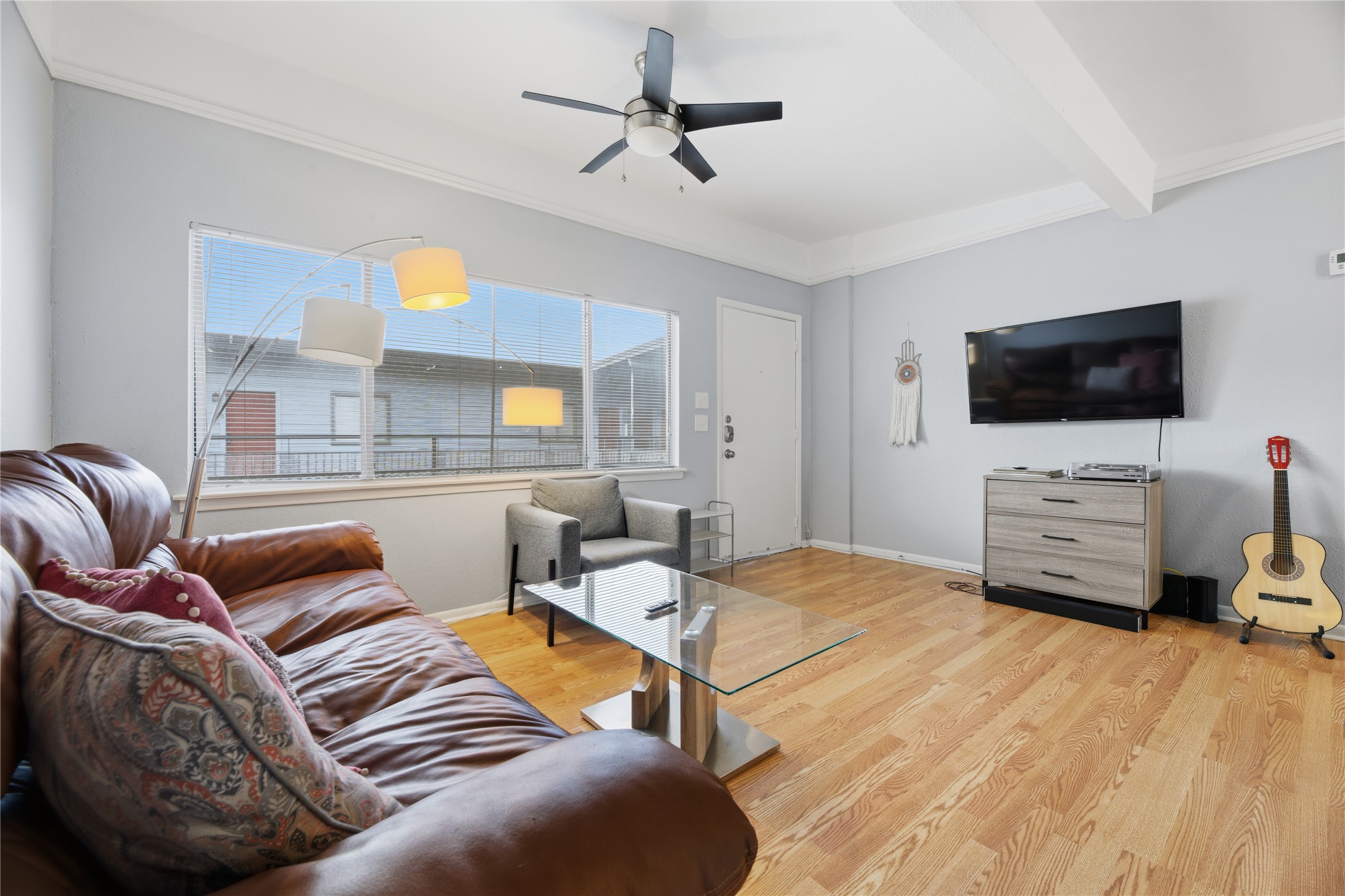 2408 Longview Street, Unit 204 Austin, TX 78705 - Photo 4 of 17 a bedroom with furniture and a flat screen tv
