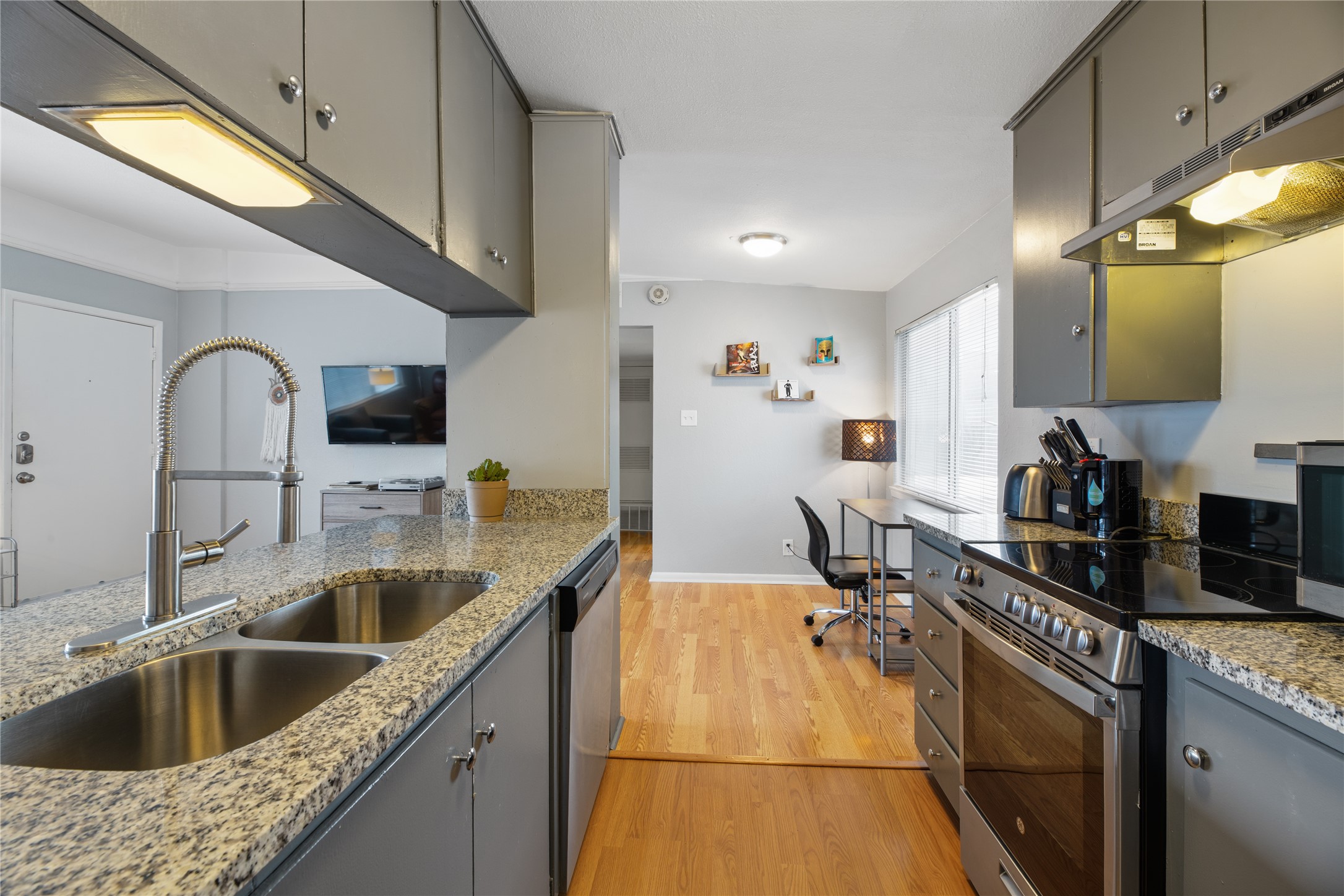 2408 Longview Street, Unit 204 Austin, TX 78705 - Photo 9 of 17 a kitchen with a sink a counter and cabinets