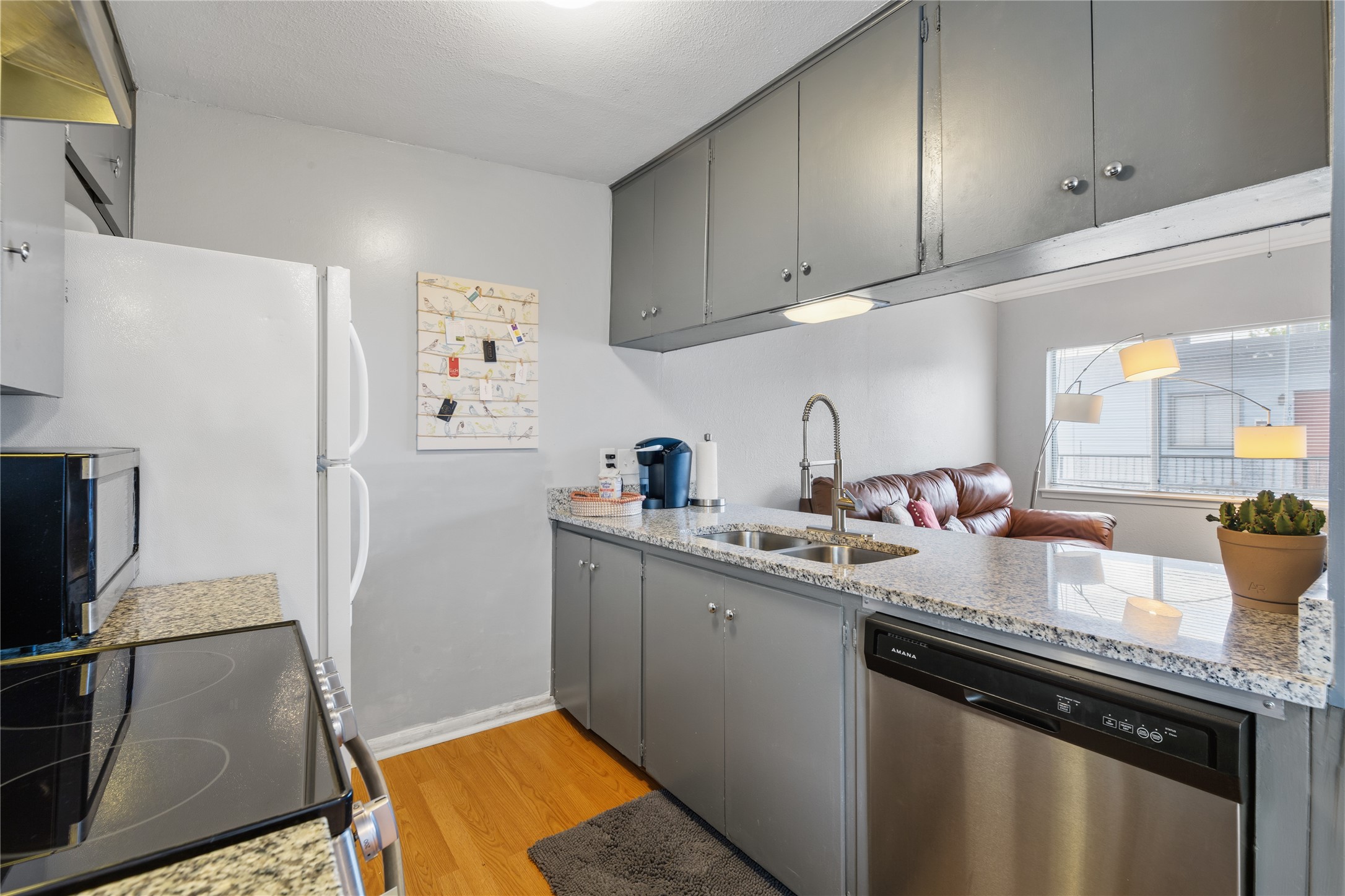 2408 Longview Street, Unit 204 Austin, TX 78705 - Photo 10 of 17 a kitchen with stainless steel appliances granite countertop a sink stove and refrigerator
