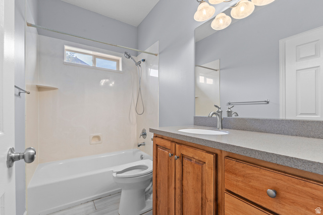 1501 West Elk Circle Mapleton, UT 84664 - Photo 28 of 39 Bathroom featuring a tub/shower combination, transom window, wood-finish vanity with a single basin sink, and a large mirror