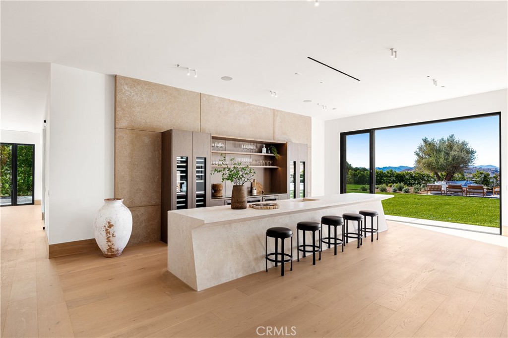 25151 Jim Bridger Road Hidden Hills, CA 91302 - Photo 12 of 32 a large white kitchen with a large window