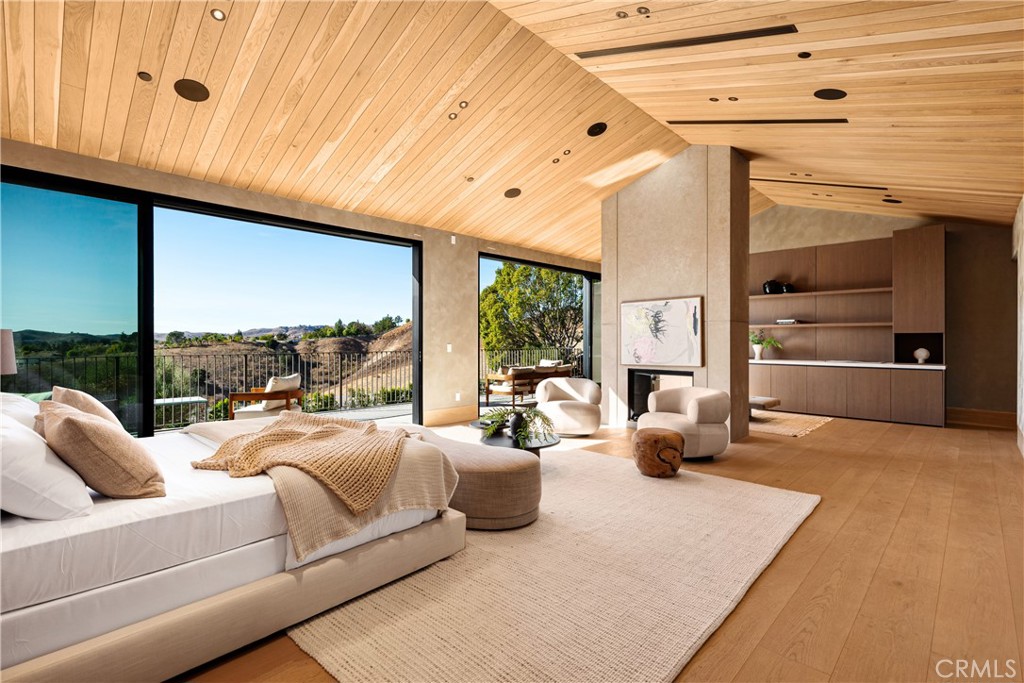 25151 Jim Bridger Road Hidden Hills, CA 91302 - Photo 20 of 32 a bedroom with furniture and a large window