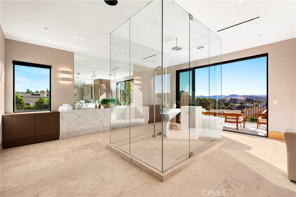 25151 Jim Bridger Road Hidden Hills, CA 91302 - Photo 21 of 32 a living room with furniture a large window with kitchen view