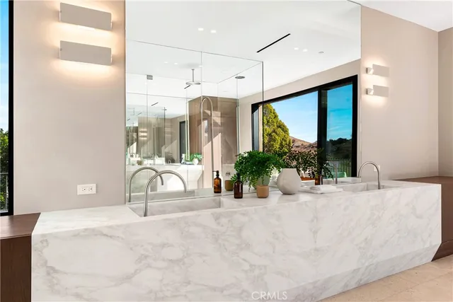 a bathroom with a granite countertop sink mirror and shower