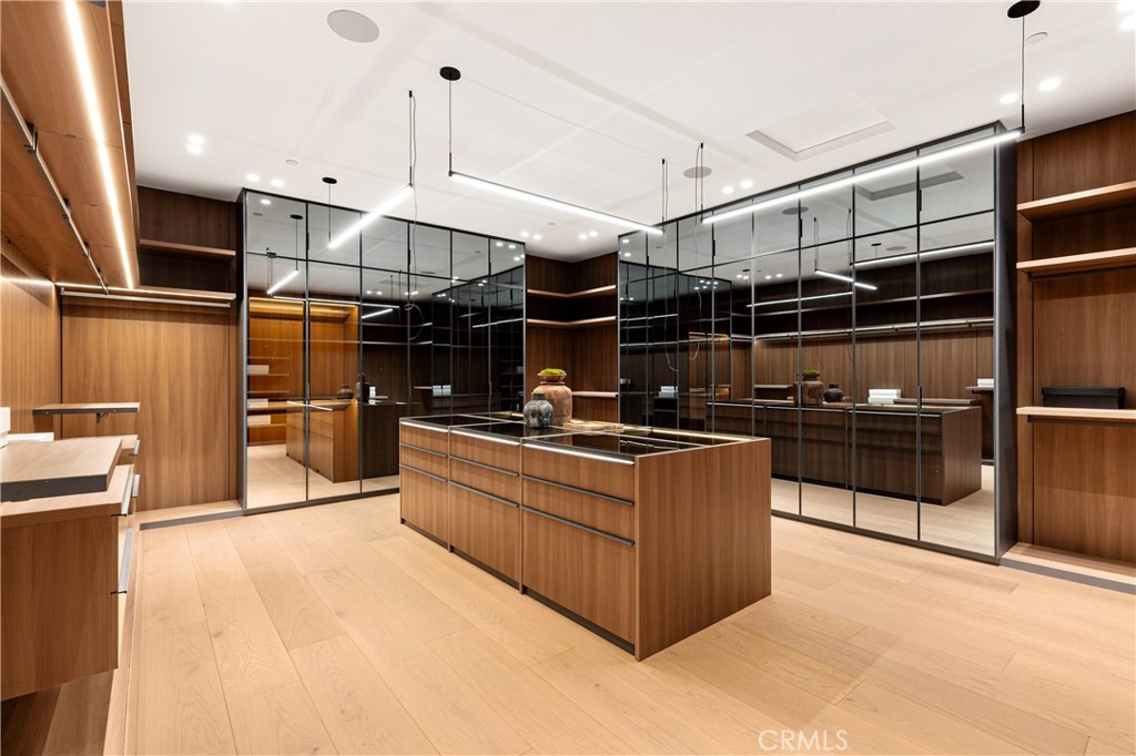 25151 Jim Bridger Road Hidden Hills, CA 91302 - Photo 24 of 32 a kitchen with stainless steel appliances granite countertop a sink and wooden cabinets