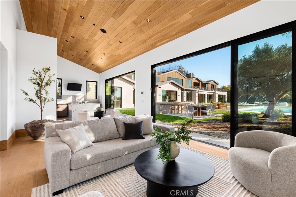 25151 Jim Bridger Road Hidden Hills, CA 91302 - Photo 25 of 32 a living room with furniture fireplace and a large window