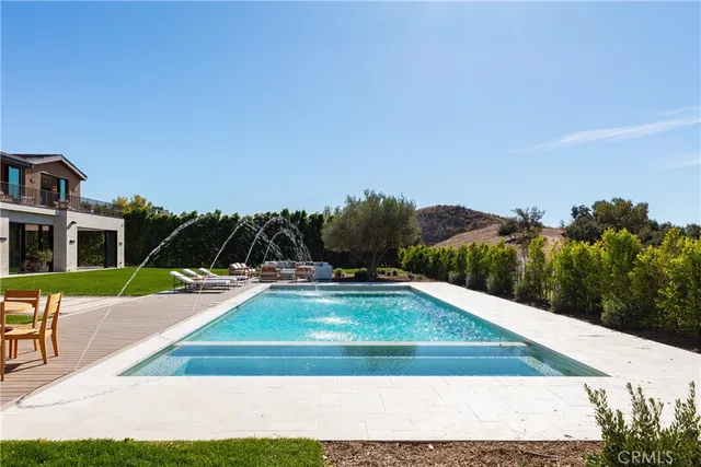 a view of a swimming pool with a yard