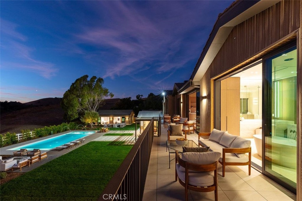 25151 Jim Bridger Road Hidden Hills, CA 91302 - Photo 29 of 32 a view of swimming pool with outdoor seating