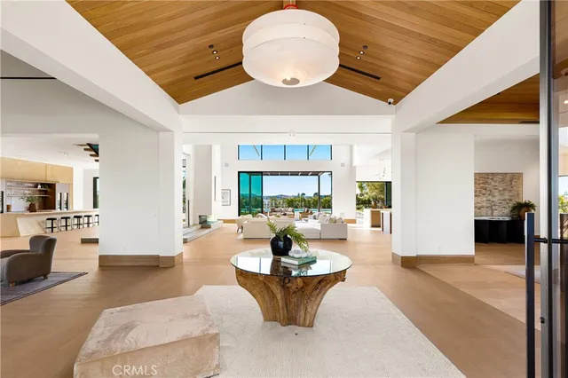 a living room with fireplace furniture and a large window