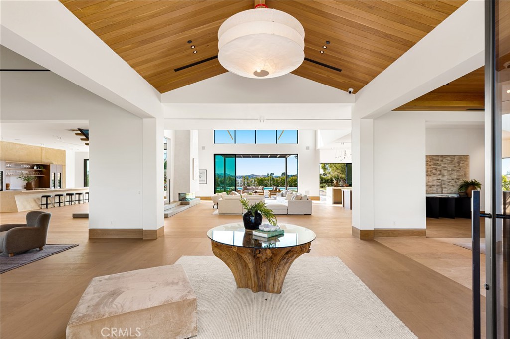 25151 Jim Bridger Road Hidden Hills, CA 91302 - Photo 3 of 32 a living room with fireplace furniture and a large window