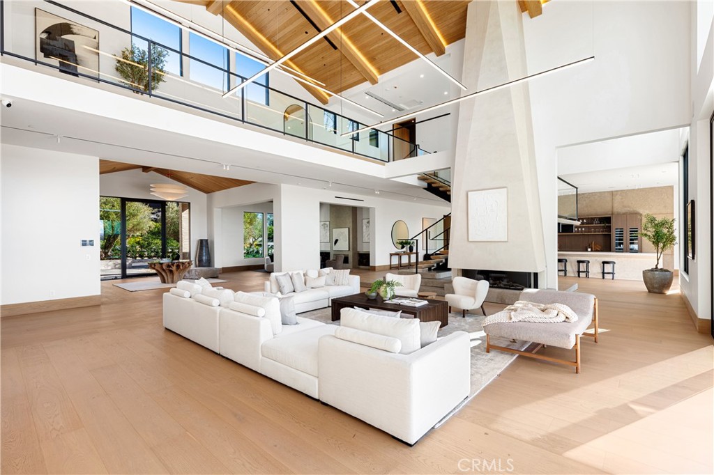 25151 Jim Bridger Road Hidden Hills, CA 91302 - Photo 6 of 32 a living room with furniture and a chandelier