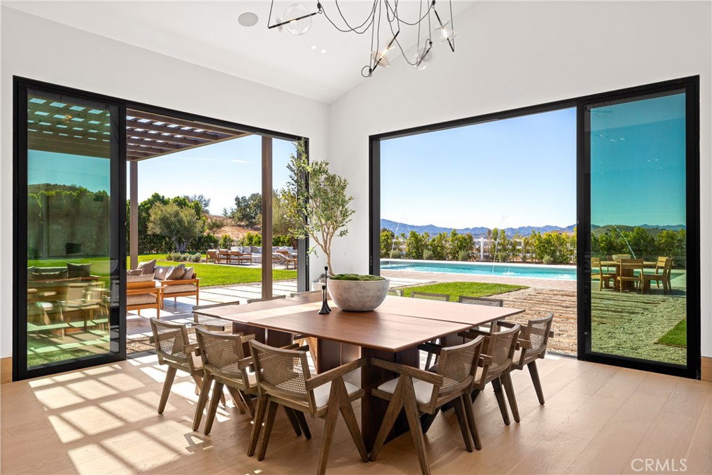 25151 Jim Bridger Road Hidden Hills, CA 91302 - Photo 9 of 32 a view of a dining room with furniture window and outside view