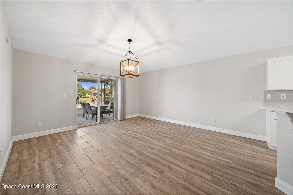 600 Benton Drive Melbourne, FL 32901 - Photo 15 of 33 a view of an empty room with window and wooden floor
