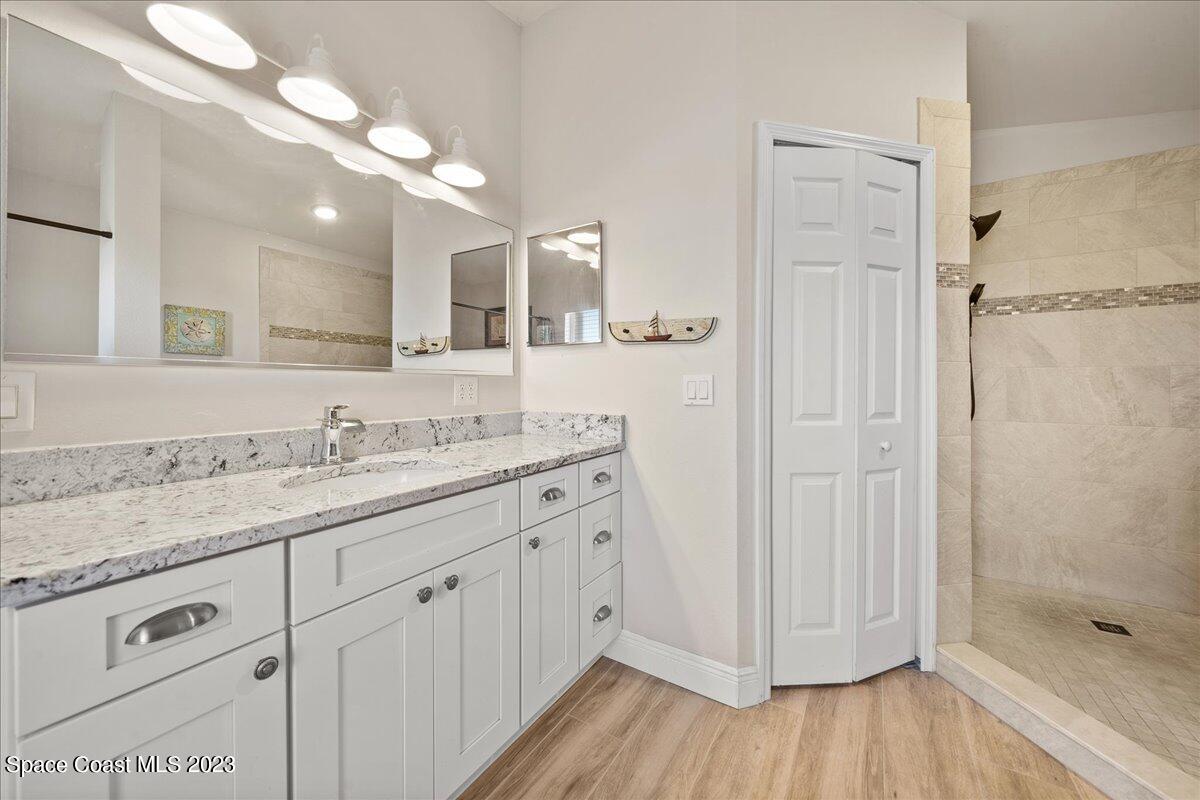 600 Benton Drive Melbourne, FL 32901 - Photo 20 of 33 a bathroom with a granite countertop sink mirror and shower