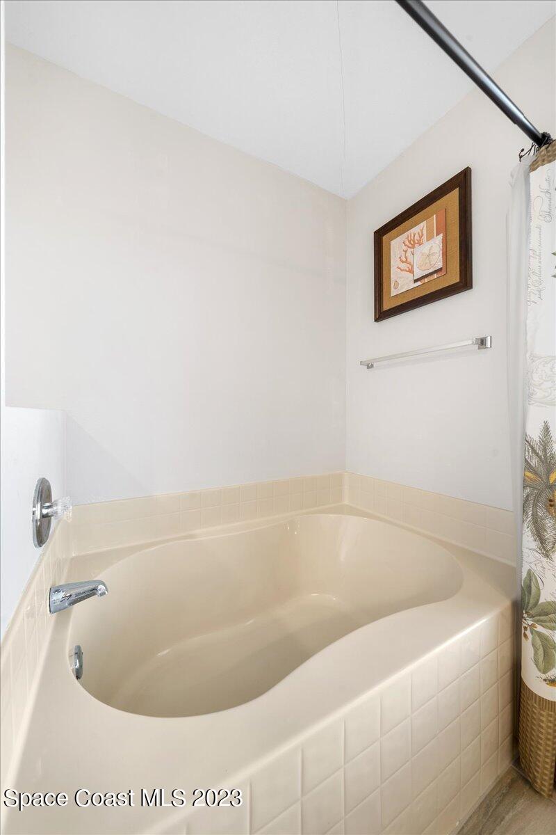 600 Benton Drive Melbourne, FL 32901 - Photo 22 of 33 a white bath tub sitting in a bathroom
