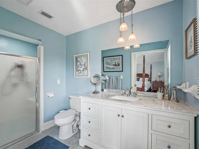 a bathroom with a toilet a sink and a mirror