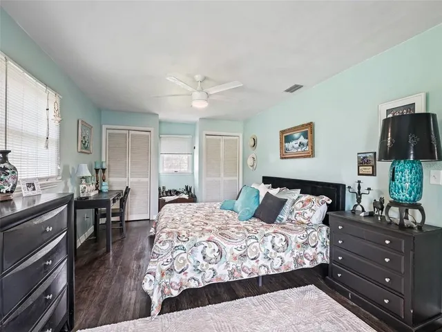 a bedroom with a bed and wooden floor