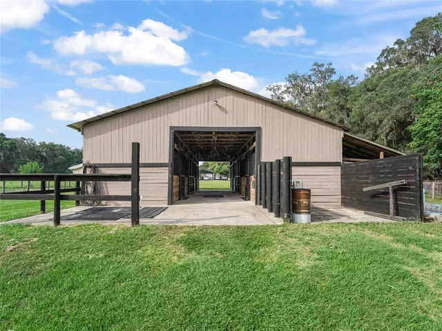 a view of house with backyard and a garden