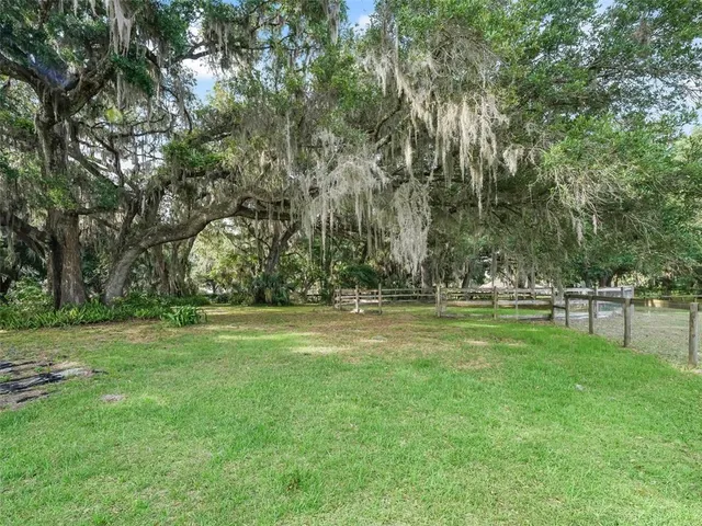 a view of outdoor space with deck and trees