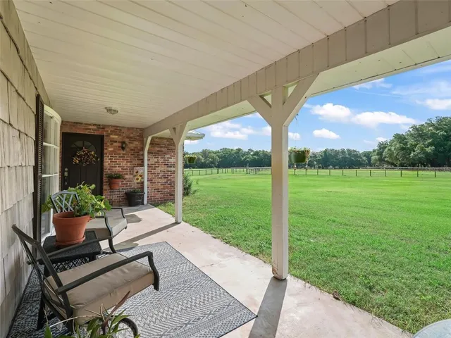 a building outdoor space with patio furniture and garden