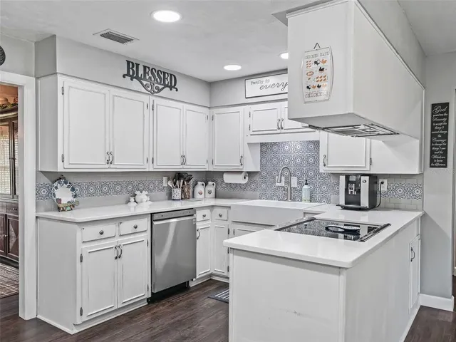 a kitchen with cabinets appliances a sink and a stove