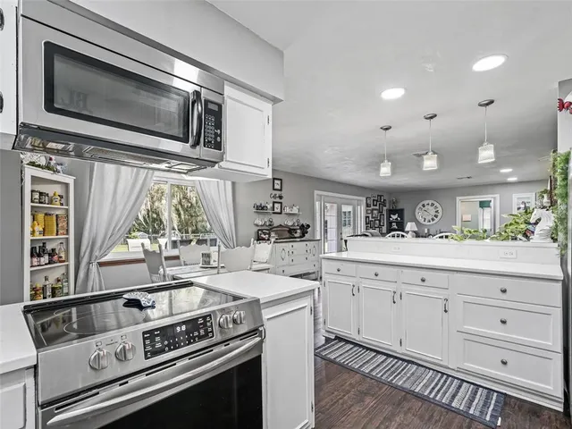 a kitchen with a stove and a microwave