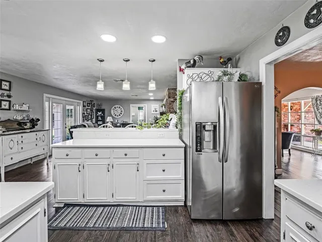 a kitchen with stainless steel appliances a refrigerator sink and cabinets