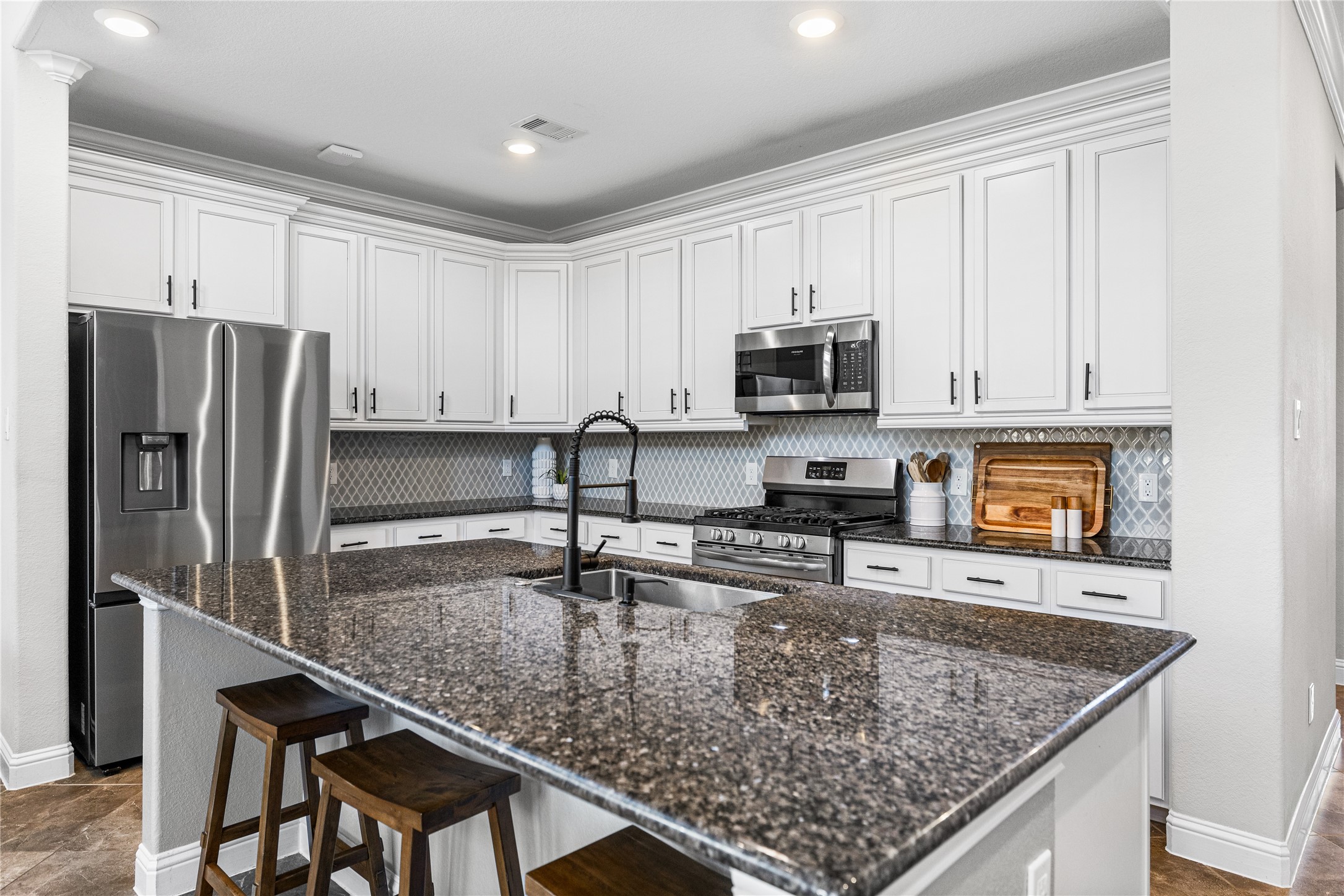 4320 Silver Oak Place Spring, TX 77386 - Photo 5 of 42 Generous kitchen featuring a large island and stainless steel appliances.