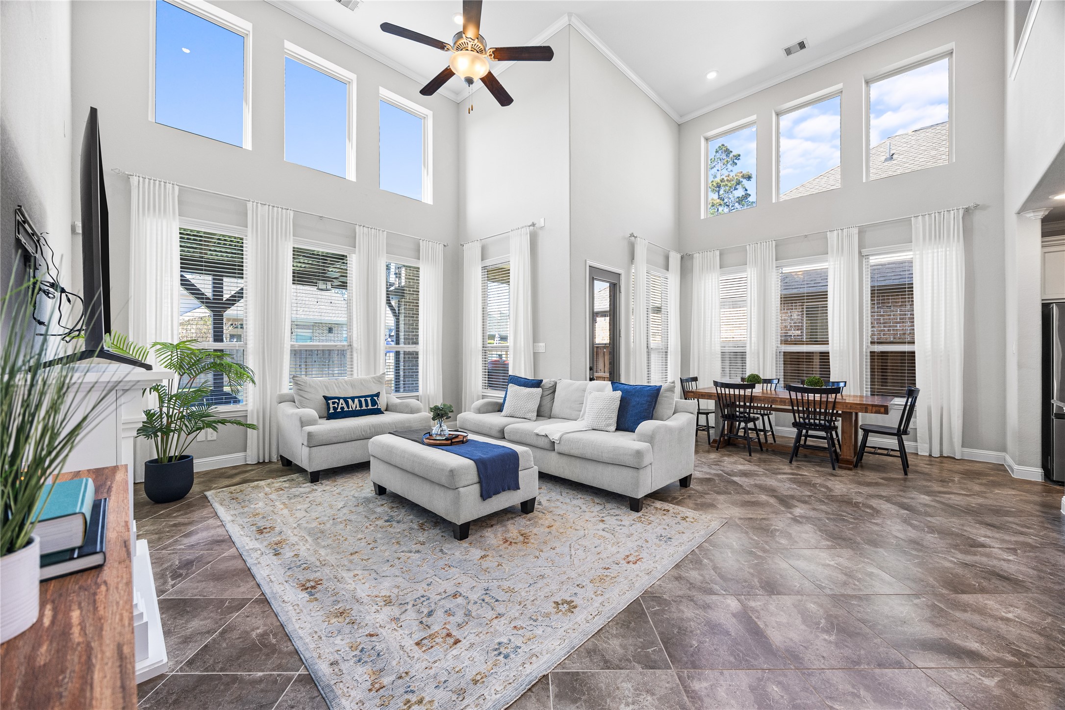 4320 Silver Oak Place Spring, TX 77386 - Photo 7 of 42 Spacious living area with high ceilings and plenty of natural light, offering an open and airy feel ideal for relaxing or entertaining.